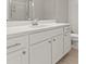 Bright bathroom features white cabinetry, quartz countertop, and a glass-enclosed shower at 1556 Olivia Pkwy, Henderson, NV 89011