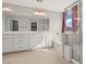 Bright bathroom with double vanity, large mirror, and a glass-enclosed shower at 1556 Olivia Pkwy, Henderson, NV 89011