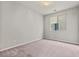 Bedroom with neutral walls, carpeted floor, and a bright window at 1556 Olivia Pkwy, Henderson, NV 89011