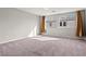 Bright bedroom with plush carpet, neutral walls, and natural light from large windows at 1556 Olivia Pkwy, Henderson, NV 89011