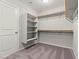 Walk-in closet with carpet, shelving, and hanging rods for ample storage at 1556 Olivia Pkwy, Henderson, NV 89011