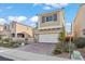 Charming two-story home featuring a two-car garage, desert landscaping, and elegant architectural details at 1556 Olivia Pkwy, Henderson, NV 89011