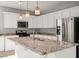 Kitchen island with granite countertop, stainless steel appliances, and pendant lighting at 1556 Olivia Pkwy, Henderson, NV 89011