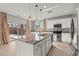 Kitchen island with granite countertop and stainless steel appliances, next to a sliding glass door at 1556 Olivia Pkwy, Henderson, NV 89011