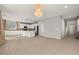 Bright living room with tiled floors, white kitchen, and a stunning chandelier at 1556 Olivia Pkwy, Henderson, NV 89011
