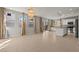 Open-concept living room featuring tile flooring, natural light, and seamless access to the kitchen at 1556 Olivia Pkwy, Henderson, NV 89011