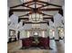 Elegant lobby featuring vaulted ceilings, exposed beams, pendant lighting, and comfortable seating areas at 1556 Olivia Pkwy, Henderson, NV 89011