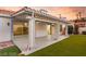 This covered back patio offers generous space for outdoor living and entertaining, overlooking the manicured backyard at 1613 Shadow Rock Dr, Las Vegas, NV 89117
