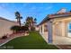 This backyard features an artificial lawn, desert landscaping, and a covered patio, ideal for entertaining at 1613 Shadow Rock Dr, Las Vegas, NV 89117