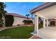 A tranquil backyard includes an artificial lawn, covered patio, and desert landscaping, providing privacy at 1613 Shadow Rock Dr, Las Vegas, NV 89117