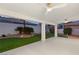 This backyard boasts a covered patio with ceiling fans, an artificial lawn, and desert landscaping at 1613 Shadow Rock Dr, Las Vegas, NV 89117