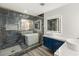 Contemporary bathroom featuring a large shower, soaking tub, and stylish blue cabinetry at 1613 Shadow Rock Dr, Las Vegas, NV 89117