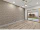 Bright bedroom featuring wood-style flooring and a sliding glass door to the patio at 1613 Shadow Rock Dr, Las Vegas, NV 89117