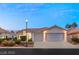 Charming single-story home featuring a well-manicured lawn, mature landscaping, and a two-car garage at 1613 Shadow Rock Dr, Las Vegas, NV 89117