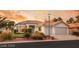 Inviting single-story home showcases lush landscaping, a tile roof, and attached two car garage at 1613 Shadow Rock Dr, Las Vegas, NV 89117