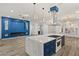 Kitchen with a marble island, custom blue cabinets, and a modern range at 1613 Shadow Rock Dr, Las Vegas, NV 89117