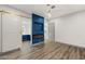 Bedroom with sliding barn door to bath, modern fireplace, and closet at 1613 Shadow Rock Dr, Las Vegas, NV 89117