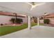 Outdoor covered patio area with stylish fans and manicured landscaping at 1613 Shadow Rock Dr, Las Vegas, NV 89117