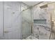 This spa-like shower features designer tile, a rainfall showerhead, and seamless glass door at 1613 Shadow Rock Dr, Las Vegas, NV 89117