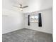 Bright bedroom featuring a window, neutral carpet and a modern ceiling fan at 1700 E Oakey Blvd, Las Vegas, NV 89104