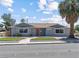 Inviting single-story home featuring well-manicured lawn, mature palm tree, and brick accents at 1700 E Oakey Blvd, Las Vegas, NV 89104