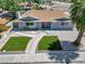 Charming single-story home with manicured front lawn and desert landscaping, enhanced by a bright red front door at 1700 E Oakey Blvd, Las Vegas, NV 89104