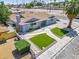 Cozy single-story home featuring an easy to maintain artificial lawn with mature trees at 1700 E Oakey Blvd, Las Vegas, NV 89104