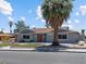 Attractive single-story home with a well-kept front yard, red door, and mature landscaping at 1700 E Oakey Blvd, Las Vegas, NV 89104