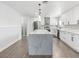 Spacious, bright kitchen with quartz island, stainless appliances, and modern white cabinets at 1700 E Oakey Blvd, Las Vegas, NV 89104