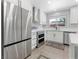 Bright kitchen features stainless steel appliances, double oven, modern white cabinets, and a mosaic tile backsplash at 1700 E Oakey Blvd, Las Vegas, NV 89104