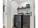 This laundry room features a modern washer and dryer, floating shelves, and a sliding door at 1700 E Oakey Blvd, Las Vegas, NV 89104