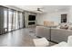 Living room with hardwood floors, gray sectional sofa, and sliding glass doors at 1700 E Oakey Blvd, Las Vegas, NV 89104