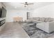 Bright living room featuring a gray sofa, a wall clock, and a modern fireplace at 1700 E Oakey Blvd, Las Vegas, NV 89104