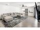 Open-concept living room featuring a gray sectional sofa, modern rug, and hardwood floors at 1700 E Oakey Blvd, Las Vegas, NV 89104