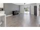 Open living space with gray walls, wood floors, ceiling fan, and sliding door to backyard at 1700 E Oakey Blvd, Las Vegas, NV 89104