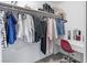 Well-lit walk-in closet with ample storage, a vanity area and a red chair at 1700 E Oakey Blvd, Las Vegas, NV 89104