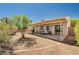 Large backyard with covered patio, desert landscaping, and a charming garden area at 1902 Panther Pl, North Las Vegas, NV 89031