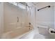 Bright, tiled bathroom showcases a shower-tub combination with grab bar and a modern toilet with paper holder at 1902 Panther Pl, North Las Vegas, NV 89031