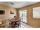 Cozy dining area with wood table, chairs, and sliding glass doors to the backyard at 1902 Panther Pl, North Las Vegas, NV 89031