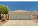 Home exterior featuring a large driveway and a spacious two-car garage with neutral-colored doors at 1902 Panther Pl, North Las Vegas, NV 89031