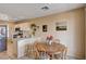 Open kitchen and breakfast nook with white cabinets and a dining table and chairs at 1902 Panther Pl, North Las Vegas, NV 89031