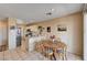 Open kitchen and breakfast nook with white cabinets and a dining table and chairs at 1902 Panther Pl, North Las Vegas, NV 89031
