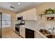 Well-lit kitchen featuring white cabinets, marble countertops, and stainless steel appliances at 1902 Panther Pl, North Las Vegas, NV 89031