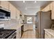 Well-equipped kitchen featuring white cabinets, stainless steel appliances, and tiled flooring at 1902 Panther Pl, North Las Vegas, NV 89031