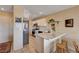 Kitchen featuring breakfast bar, stainless steel appliances, white cabinets, and neutral tones at 1902 Panther Pl, North Las Vegas, NV 89031
