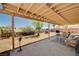 Spacious covered patio with gravel landscape and ample seating perfect for outdoor entertaining at 1902 Panther Pl, North Las Vegas, NV 89031