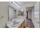 Bright bathroom showcases a vanity with a large mirror and a doorway leading back to the bedroom at 2040 Mesquite Ln # 203, Laughlin, NV 89029