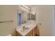 Bathroom with a sink and vanity with a mirror and storage, including vinyl wood-look floors at 2040 Mesquite Ln # 203, Laughlin, NV 89029