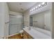 Well-lit bathroom offers a shower with sliding glass doors, modern lighting, and a large mirror at 2040 Mesquite Ln # 203, Laughlin, NV 89029