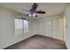 Bright bedroom featuring a ceiling fan, carpet floors, and large closet space at 2040 Mesquite Ln # 203, Laughlin, NV 89029
